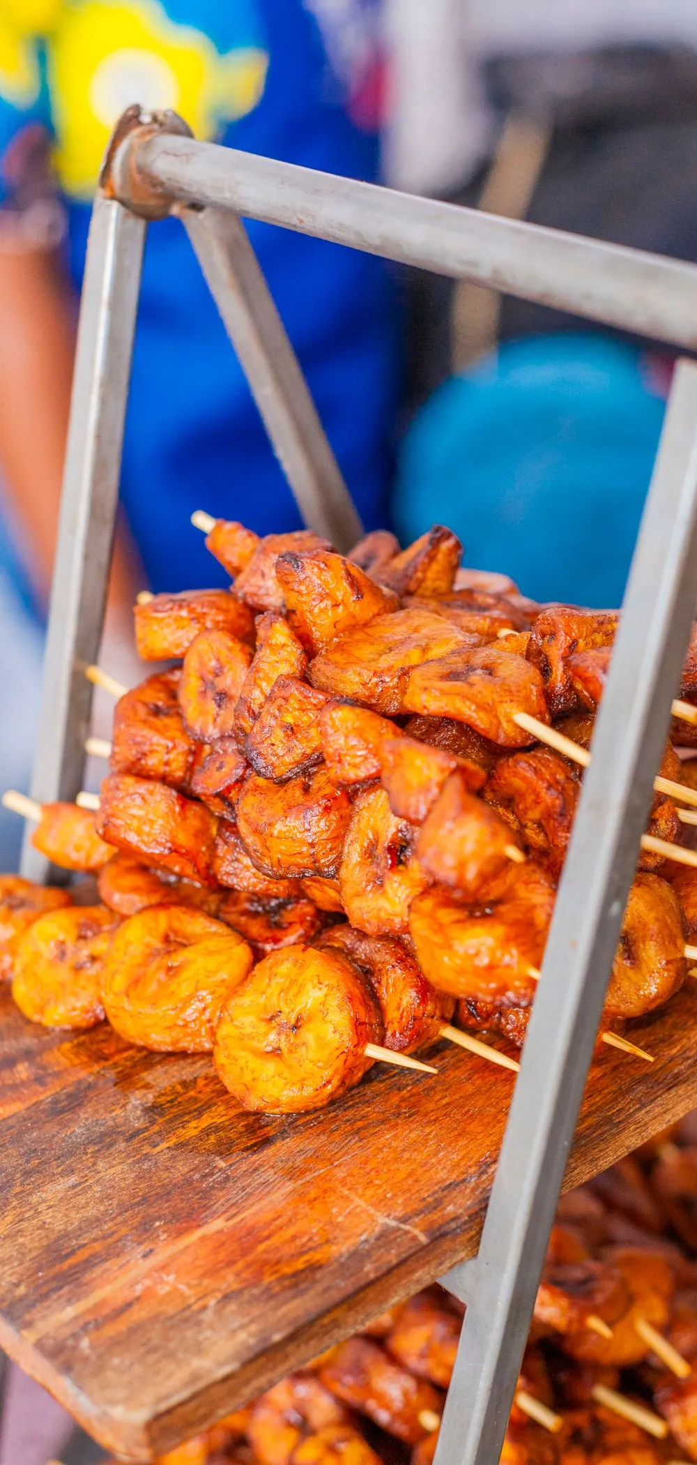 Grilled plantain stacked on a wooden stand